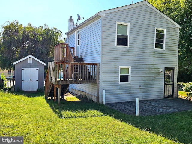 rear view of house featuring an outbuilding, a lawn, a storage shed, a chimney, and a patio area