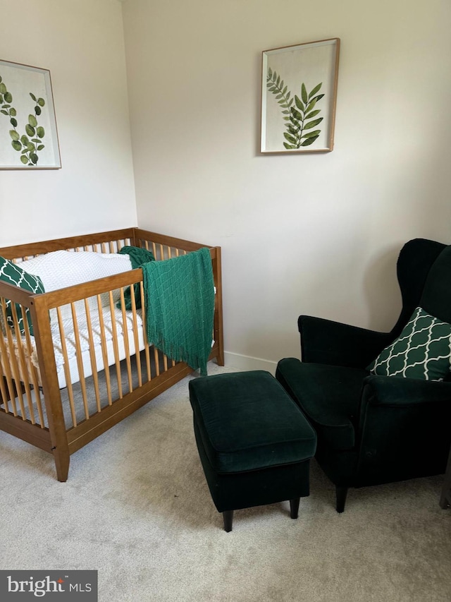 bedroom featuring a crib and carpet flooring