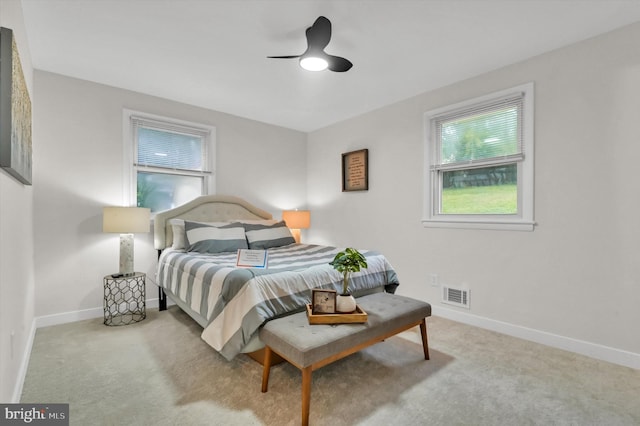 bedroom with ceiling fan and light carpet