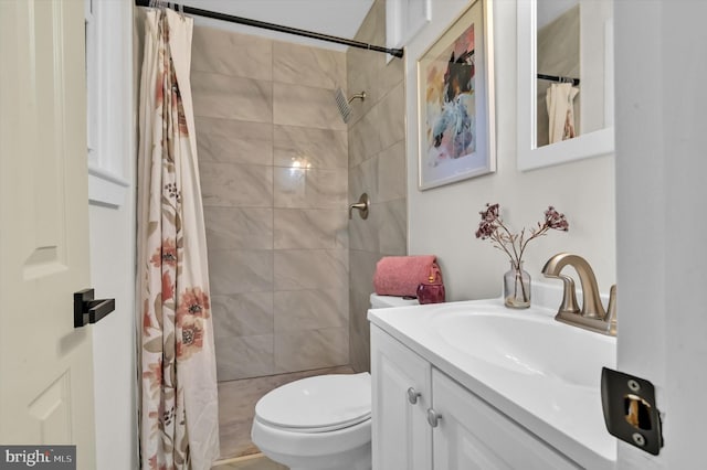 bathroom with curtained shower, vanity, and toilet