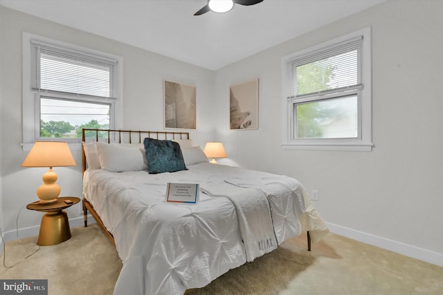 bedroom with multiple windows, ceiling fan, and carpet flooring