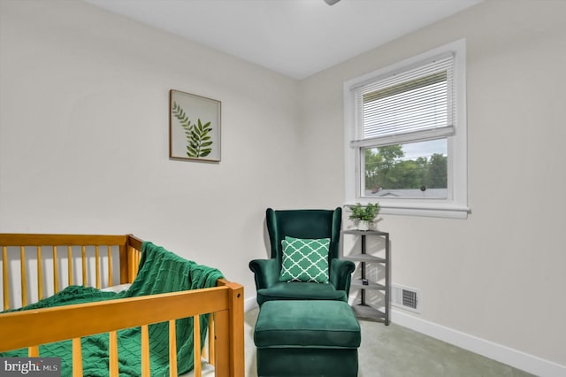 bedroom with a crib and carpet