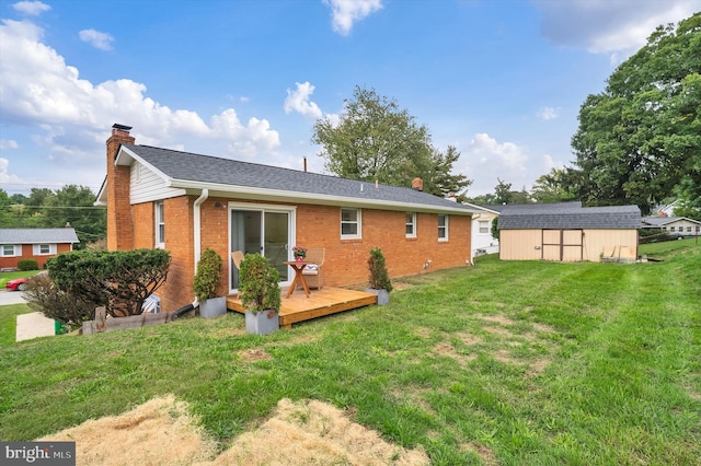 back of house with a deck, a lawn, and a shed