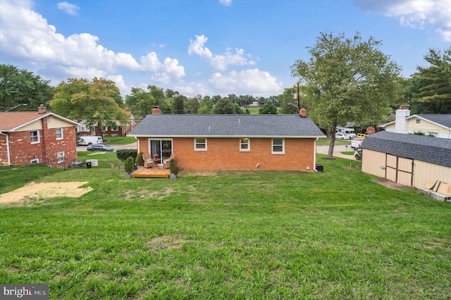 back of house featuring a deck, a yard, and a shed