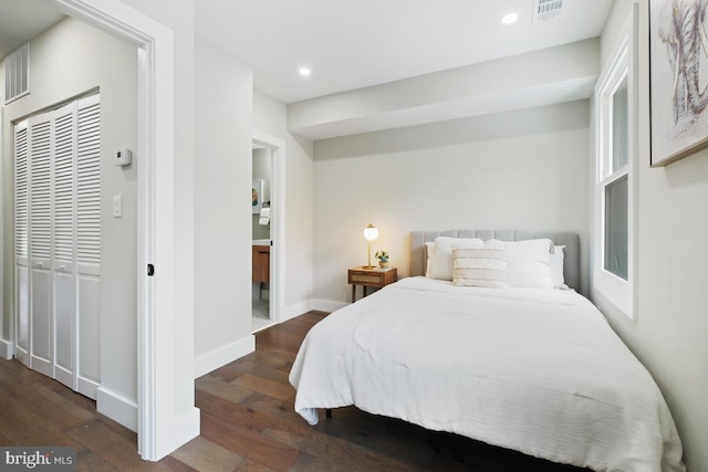 bedroom featuring a closet and dark hardwood / wood-style floors