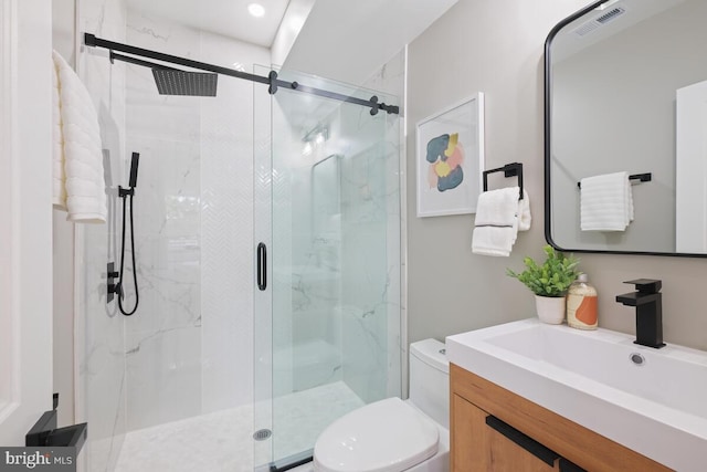 bathroom featuring walk in shower, vanity, and toilet