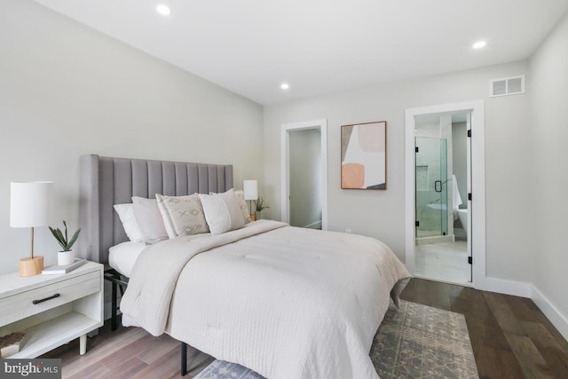 bedroom with connected bathroom and wood-type flooring