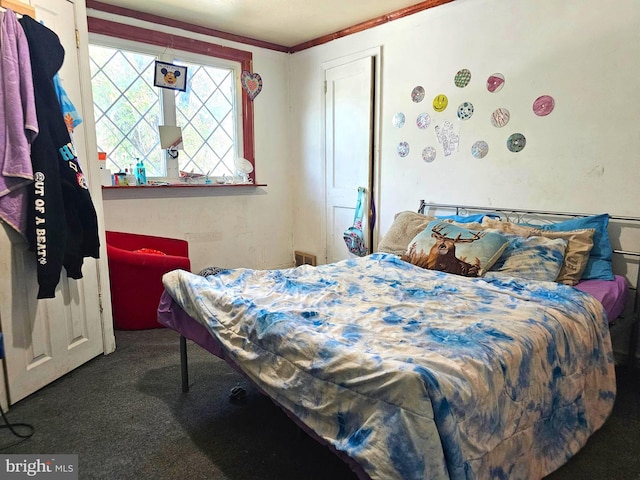 bedroom featuring ornamental molding and carpet floors