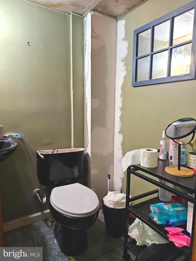 bathroom with tile patterned flooring and toilet