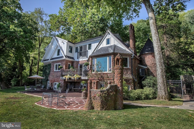 rear view of property with a patio area and a lawn