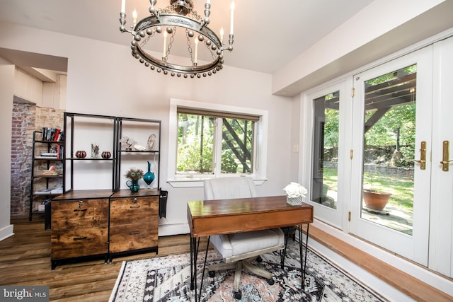 home office with plenty of natural light, baseboard heating, a chandelier, and hardwood / wood-style flooring