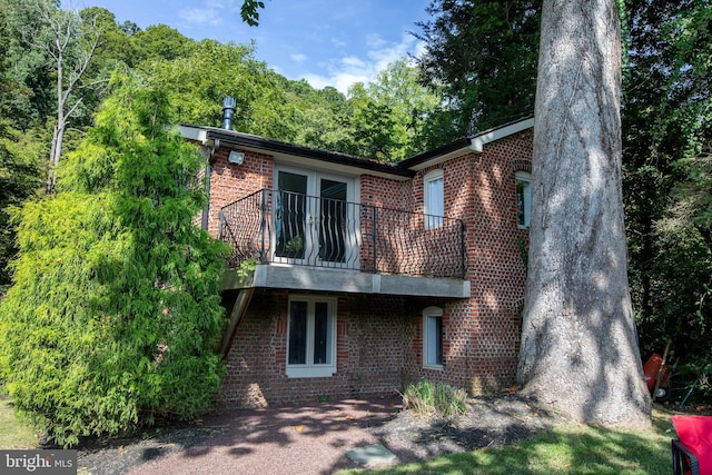 back of house featuring a balcony