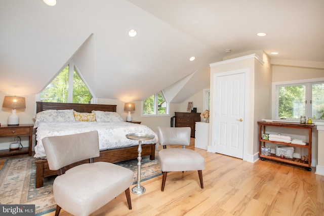 bedroom featuring lofted ceiling and light hardwood / wood-style floors