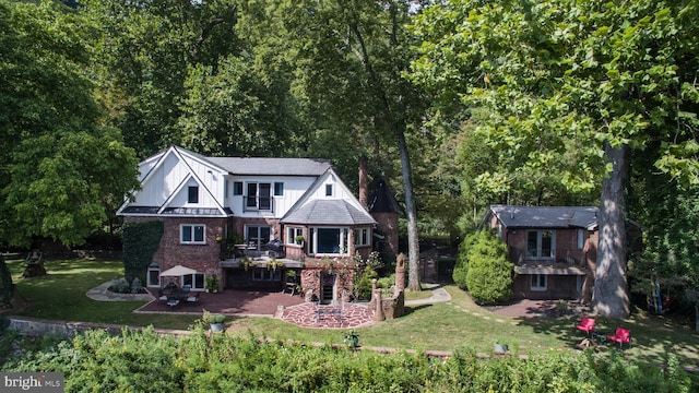 rear view of house featuring a yard