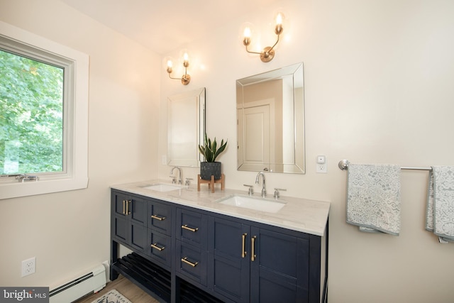 bathroom featuring hardwood / wood-style floors, a baseboard radiator, a wealth of natural light, and vanity