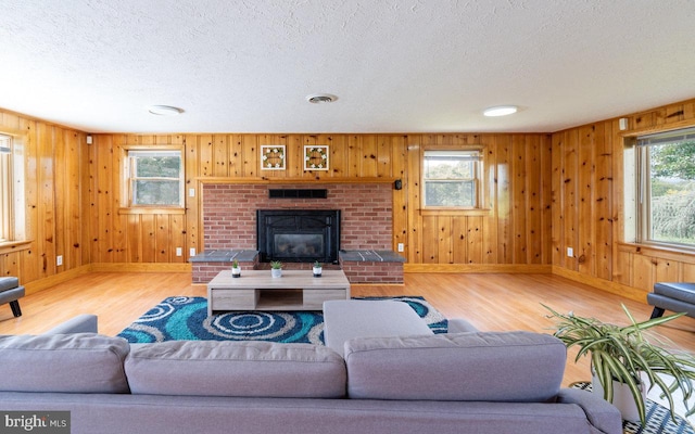 living room with plenty of natural light, hardwood / wood-style flooring, and a fireplace