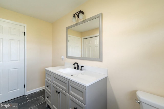 bathroom featuring vanity, toilet, and tile patterned floors