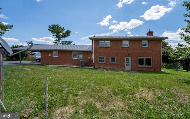 back of house featuring a lawn, a patio area, and central AC unit