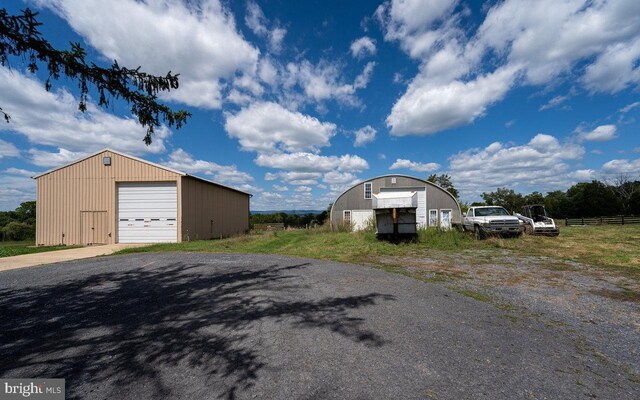 view of side of property with an outbuilding and a garage