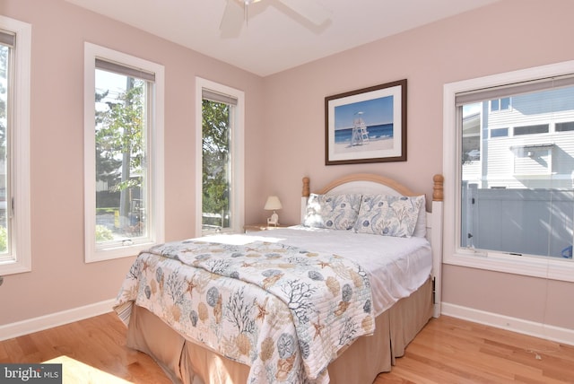 bedroom with light hardwood / wood-style floors and ceiling fan