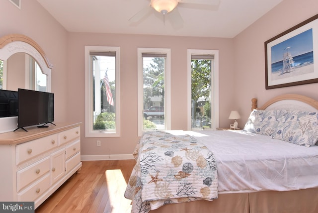 bedroom with light hardwood / wood-style flooring and ceiling fan