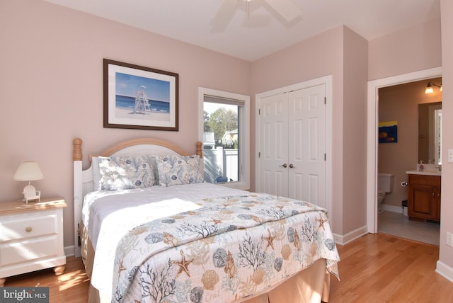 bedroom with ceiling fan, a closet, connected bathroom, and light hardwood / wood-style floors