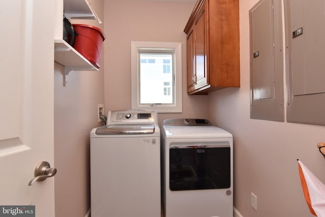 laundry area with cabinets, electric panel, and washing machine and clothes dryer