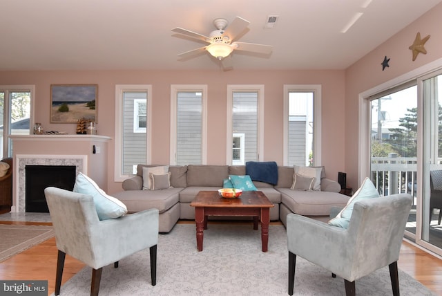 living room with ceiling fan and light hardwood / wood-style flooring