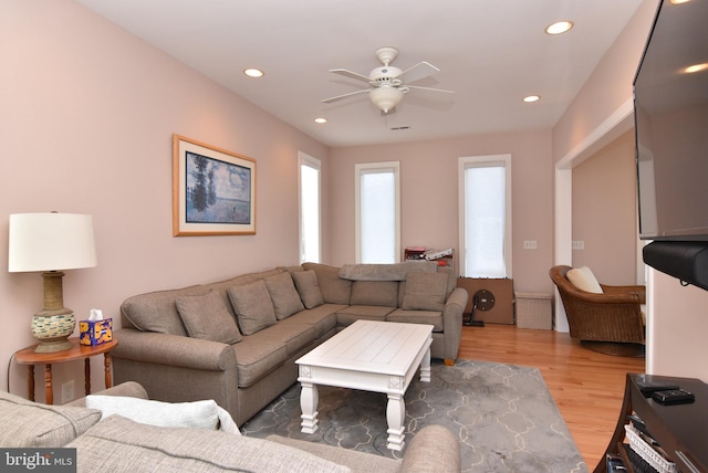 living room with ceiling fan, light wood-style flooring, and recessed lighting