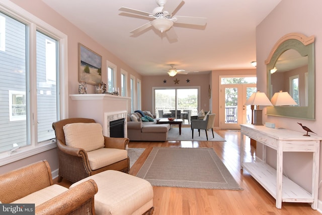 living room featuring light hardwood / wood-style floors and ceiling fan