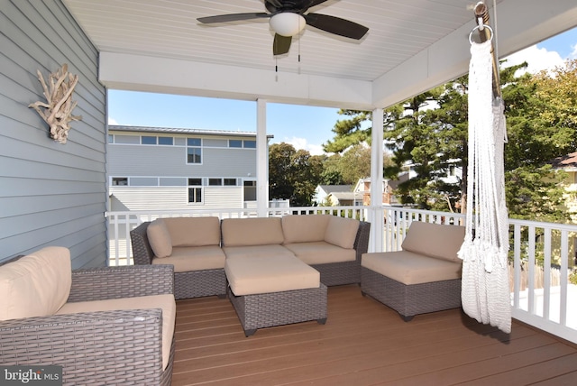 wooden terrace with ceiling fan and an outdoor hangout area