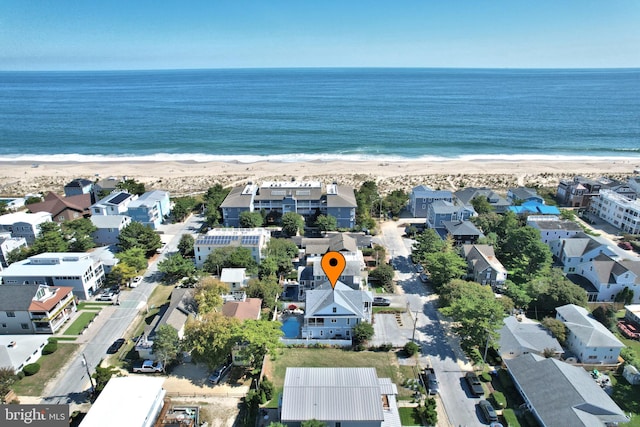 birds eye view of property featuring a view of the beach and a water view