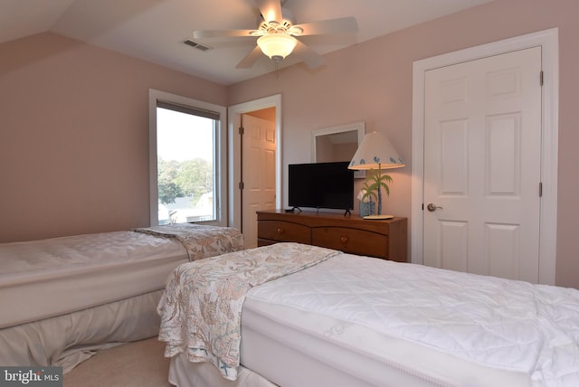 bedroom featuring vaulted ceiling, ceiling fan, and carpet floors