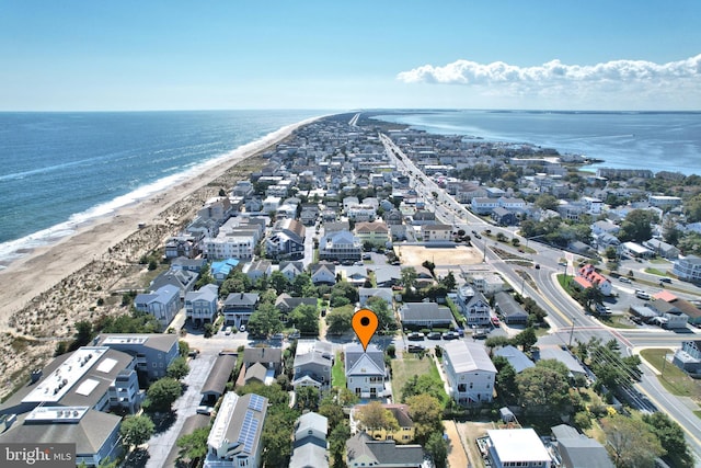 bird's eye view featuring a view of the beach, a water view, and a residential view