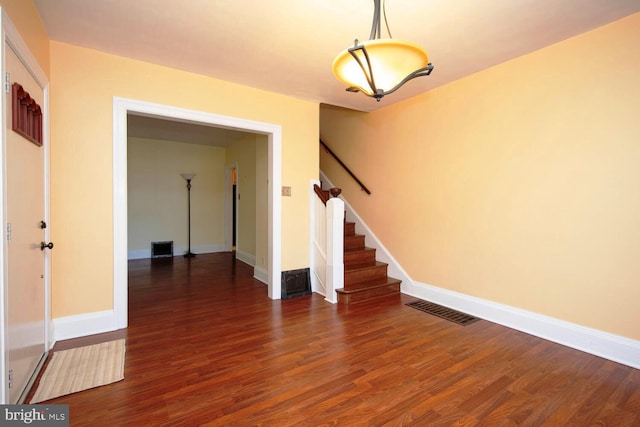 unfurnished room with dark wood-type flooring