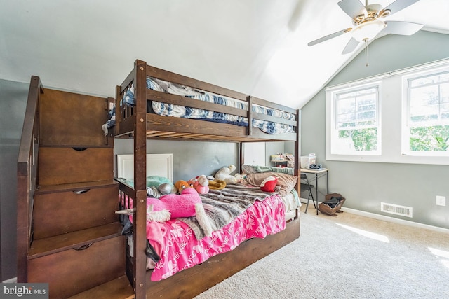 carpeted bedroom with ceiling fan and vaulted ceiling