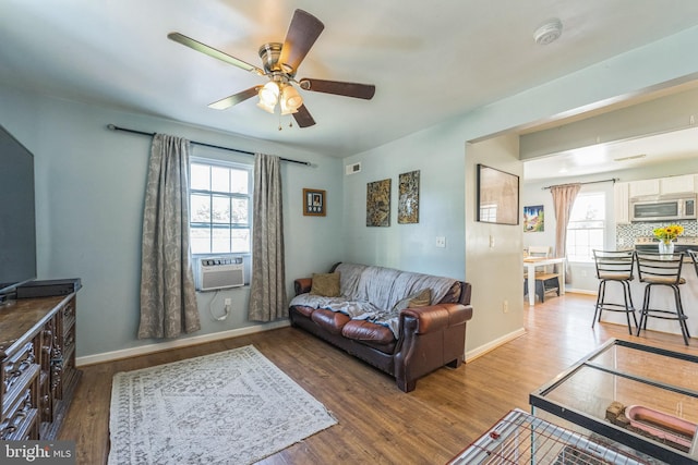 living room featuring hardwood / wood-style flooring, plenty of natural light, and ceiling fan