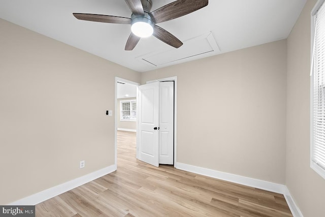 unfurnished bedroom featuring a closet, ceiling fan, multiple windows, and light hardwood / wood-style floors