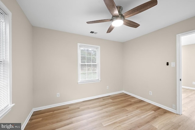 spare room with light hardwood / wood-style floors and ceiling fan