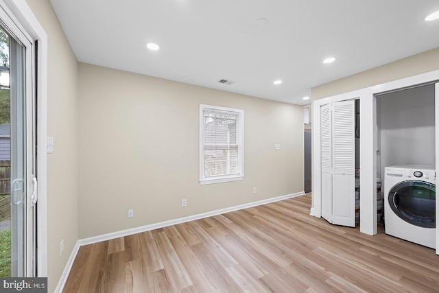 laundry area featuring light wood-type flooring and washer / clothes dryer