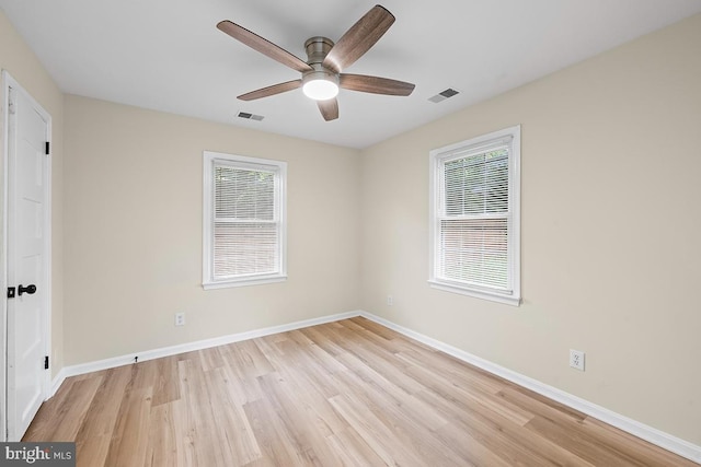 spare room featuring light hardwood / wood-style flooring and ceiling fan