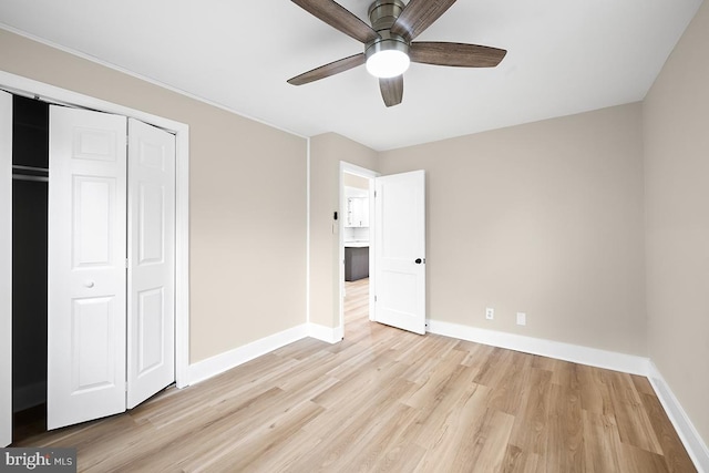 unfurnished bedroom with light hardwood / wood-style flooring, ceiling fan, and a closet