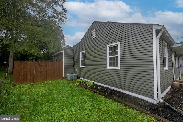 view of side of home with a yard