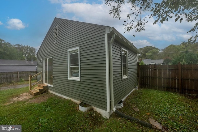 view of property exterior with a lawn