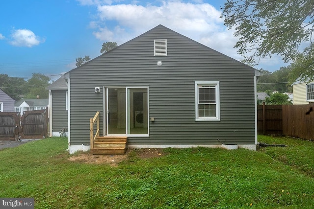 rear view of house featuring a lawn