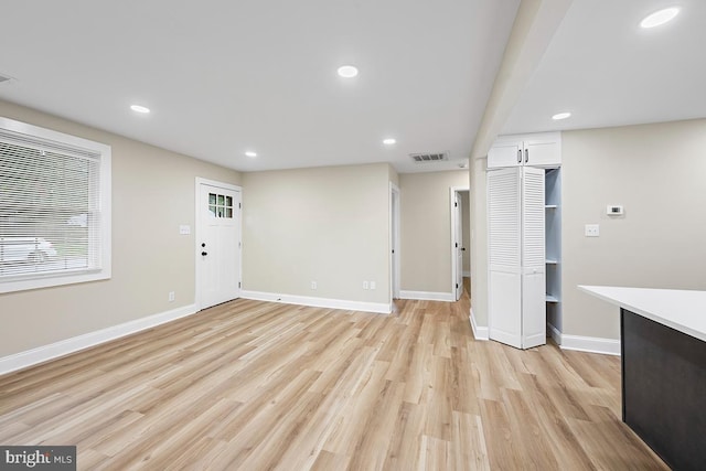 unfurnished living room with light wood-type flooring