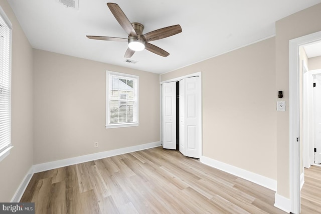 unfurnished bedroom featuring a closet, ceiling fan, and light hardwood / wood-style flooring