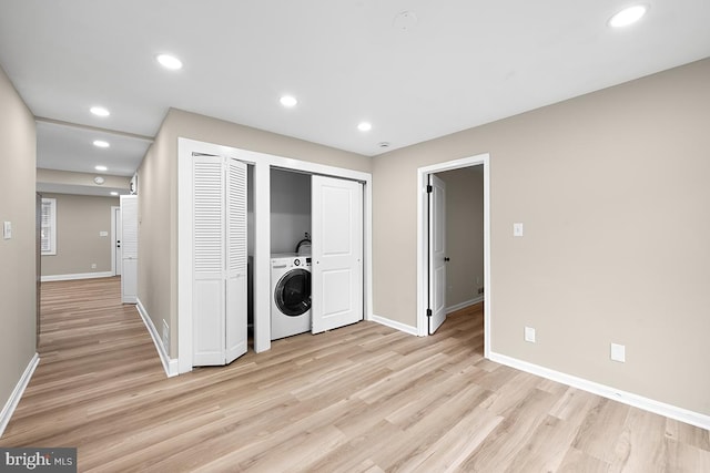 laundry area featuring light hardwood / wood-style flooring and washer / dryer