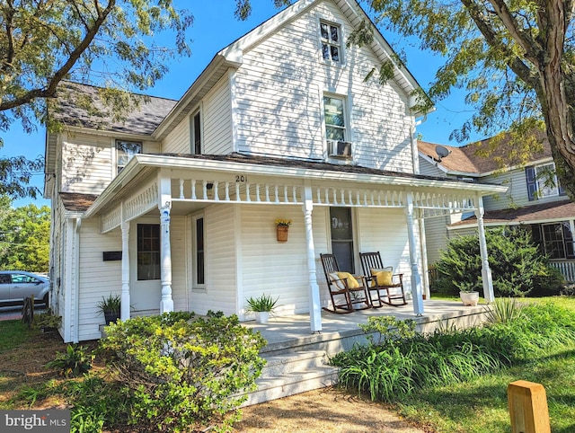 exterior space featuring cooling unit and a porch