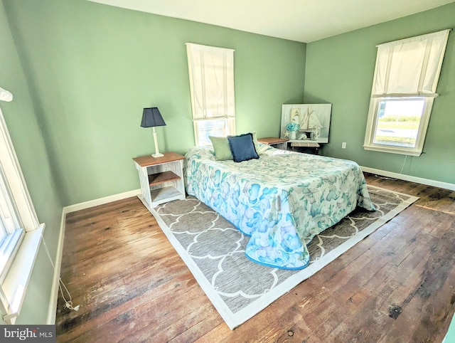 bedroom with dark wood-type flooring